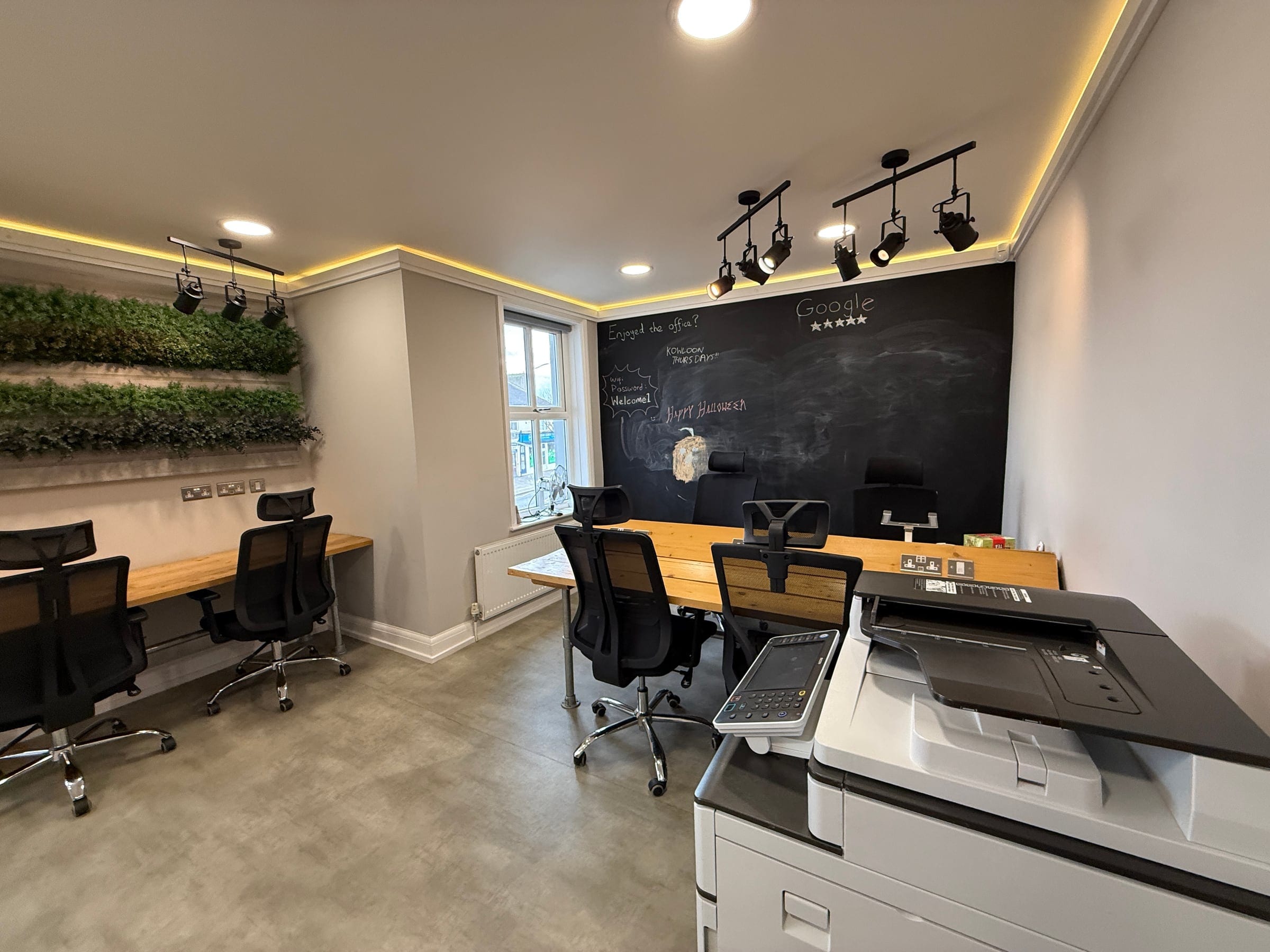 Desks and the printer in the coworking space at ShiftWorks Market Street, Hoylake