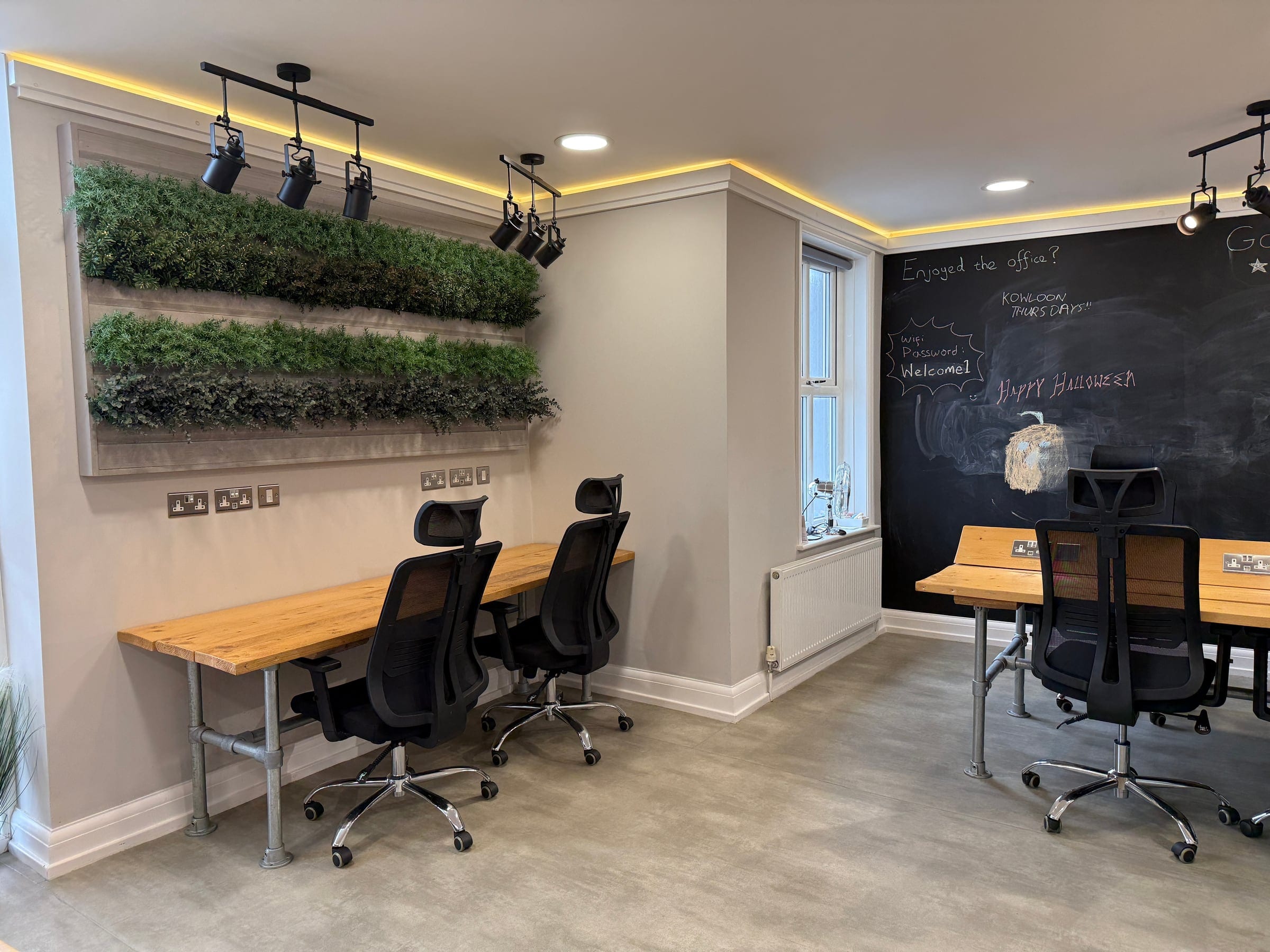 The coworking space at ShiftWorks Market Street, Hoylake, with its living wall and blackboard