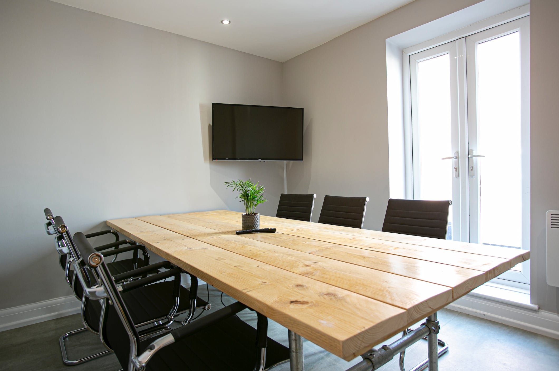 The meeting room at ShiftWorks Market Street, Hoylake, with a long table and screen
